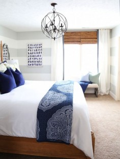Guest Bedroom with Hickory Wood Bed and Linen Headboard, Orb Chandelier, bamboo shades and DIY white ribbon-trimmed drapes.