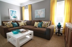 I LOVE the gray walls, brown couch, and teal accents :)