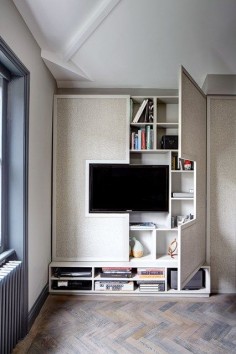 In this London flat, Sigmar has done the opposite of concealing the television by framing it with a smart, simple cabinet. Behind the cabinet doors, there is ample storage space for other audio-visual equipment, books and objects.