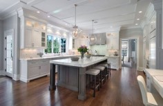 Island in different colour. Nice marble. White Kitchen With Dark Wood Floor Designs from @Home & Garden Sphere