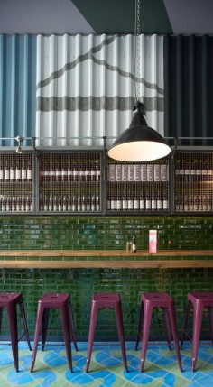 Jamie's Italian. Green tile. Mosaic floor. Pink stools. Funky Industrial interior restaurant design