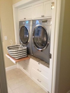 Laundry Room. Laundry Room Ideas. Laundry room machine ideas that are easy on your back. Enclosed Washer and Dryer | Laundry room features built-in cabinets encasing a silver front-load washer and dryer accented with pull out trays between cabinets with stacked drawers below. Via Decorpad.