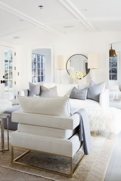 Light and bright all-white living room with touches of brass and dove gray.