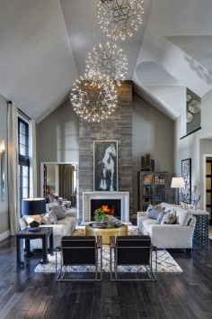 Living room, great room, dark rustic wood floors, stone fireplace, orb chandeliers, horse art | Moceri Homes