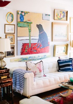 Love the eclectic mix of colorful art and textiles in this collected living room!