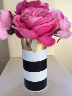 Measures 7.5 tall. Vase is hand painted white with a single gold vinyl stripe and 2 black vinyl stripes. Vase is sealed for durability. The vinyl