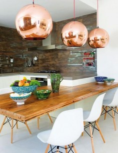 Mediterranean inspired kitchen + copper lights + wood table // Marta de la Rica