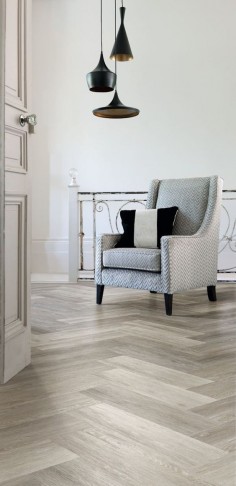 Modern herringbone parquet flooring effect created using Cavalio Conceptline luxury vinyl tiles in Limed Oak, Grey