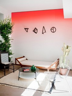 modern room with red ombre wall paint and wood daybed and mismatched chairs photographed by julie ansiau. / sfgirlbybay