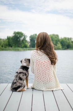 My friend Toni and her 6-month-old Miniature Australian Shepherd sitting on a dock by the lake. Pet photography. Man's best friend. Dog photography.