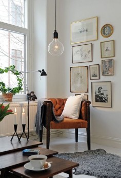 Oversized edison bulb, pendant lamp, leather chair, white walls, gallery wall