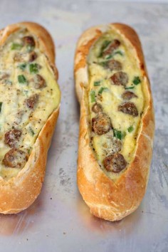 Recipe for Sausage Egg Boats - These egg boats are a new breakfast favorite because they literally take less than five minutes to prep. Sourdough baguettes filled with sausage, eggs and lots of cheese, baked until hot and toasty… so so good!