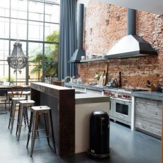 reclaimed timber, smooth concrete worktops and clean stainless-steel- industrial kitchen with a rough, rustic edge