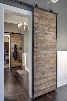 Sliding wooden doors is a great way to add rustic to a modern home. Love this interior design