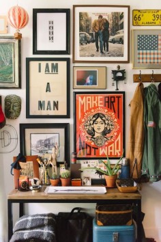 Stacked, eclectic wall art helps create a bohemian vibe | The Everygirl NYC Fizz 56 Apartment Shoot by Michelle Lange Photographer