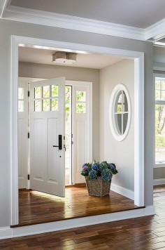 Step up leading to foyer nook, gray walls with interior window and white molding | Casa Verde Design