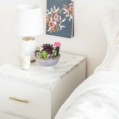 Taking a white Ikea malm and transforming it with marble contact paper and gold handles.