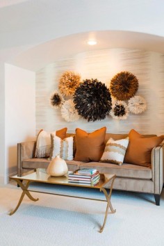 The textured wallpaper and African-inspired wall art add depth and interest to Devi and Duane's master bedroom sitting area.
