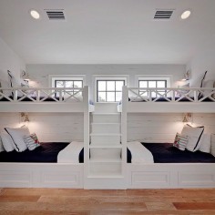 This bunk room was part of a much larger space. We designed and built these great bunks with four twin beds. I wanted it to be a space that would be comfortable for all ages and both boys and girls alike. A navy and white color scheme is both classic and crisp. The fun Otomi embroidered pillows add that fun pop of color on a sea blue cabana stripe.