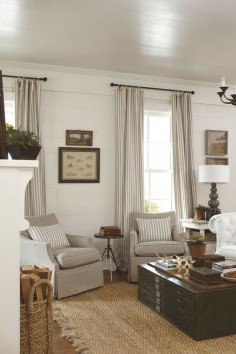 This colour scheme is using this kind of mat/ rug -white wood paneling neutral toned living room