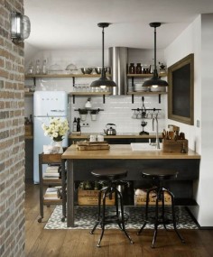 This petite kitchen nails industrial-chic by incorporating just the right amount of stainless fixtures, butcher’s block surfaces, and rustic metal accents
