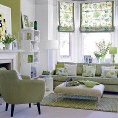 This white and green living room is alive with style. very inviting, great patterns and accents, modern furniture. Really like this space.