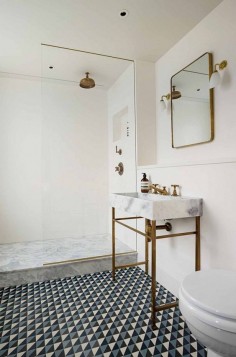 Tiled bathroom floor with marble and brass sink