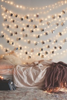 Troubled by a big, blank wall? Cover it with twinkle lights and use clothespins to attach treasured photos, as seen on the Urban Outfitters blog.