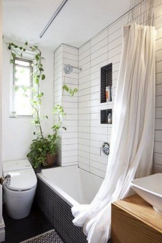 we could do this type of ceiling mounted shower curtain track in the guest bathroom - much more minimal than a standard curtain rod. again, love the accent tile in the niches.