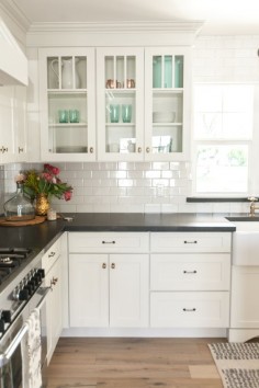 White shaker cabinetry with glass upper cabinets - as featured on 'Rafterhouse' pilot episode on HGTV.