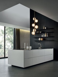 black and white contemporary kitchen - love the black wall and warm pendant lighting