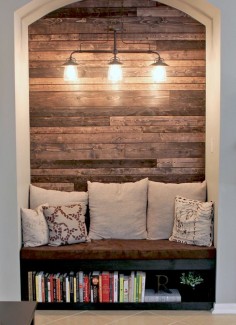 Cozy reading nook with wood plank wall.