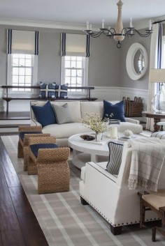 Crisp white sofas, navy blue accesories and natural ottomans VT Interiors - Library of Inspirational Images