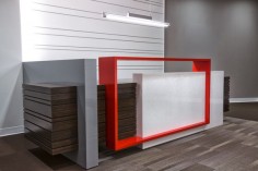 Custom designed reception desk with a welded metal accent painted in bright red to match with L3’s branding.