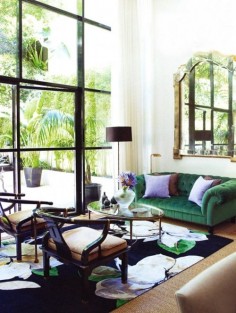gorgeous living room, green couch, black windows, mirror