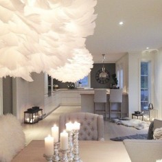 Gray, silver, white, black, faux fur, lanterns, cable knit throw, sheep skin, large clock, unique lights, chic, simple, non-cluttered