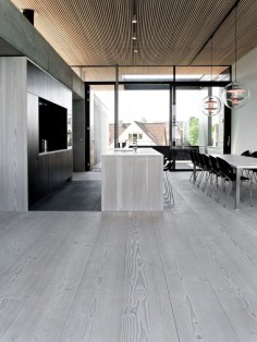Grey wood floors going up to the walls and the kitchen island. Contemporary interior design.