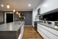 Polar White cabinets Caesarstone Oyster benchtops Dulux Lexicon on the walls and glass splashback Dulux Raku feature wall