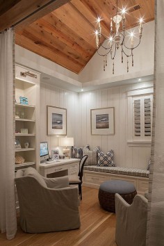 Small home office/den with reclaimed plank wood ceiling, vertical shiplap wainscoting and built-in cabinetry. Draperies add some privacy to the space. Savoie Architects.