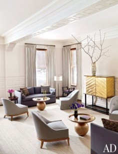 The formal living room of a Boston home by Thad Hayes features a 1950s Bjørn Wiinblad chandelier and a pair of T. H. Robsjohn-Gibbings chairs (in the foreground).