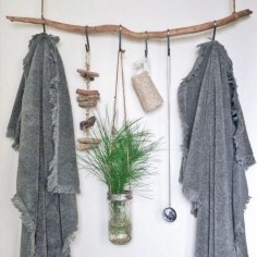 This no-build home decor project let's you hang your bathroom essentials. It's basically a hanging branch shelf with twine S-hooks for your bathroom.